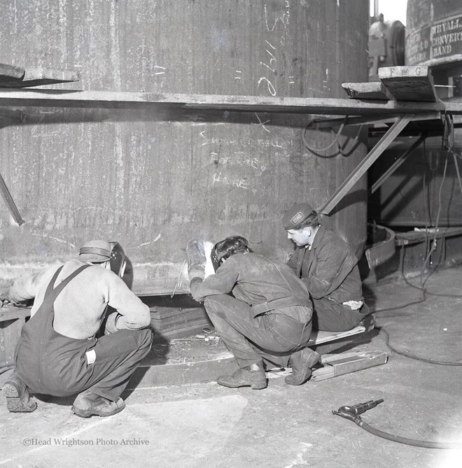 Photographs of apprentices being shown a job