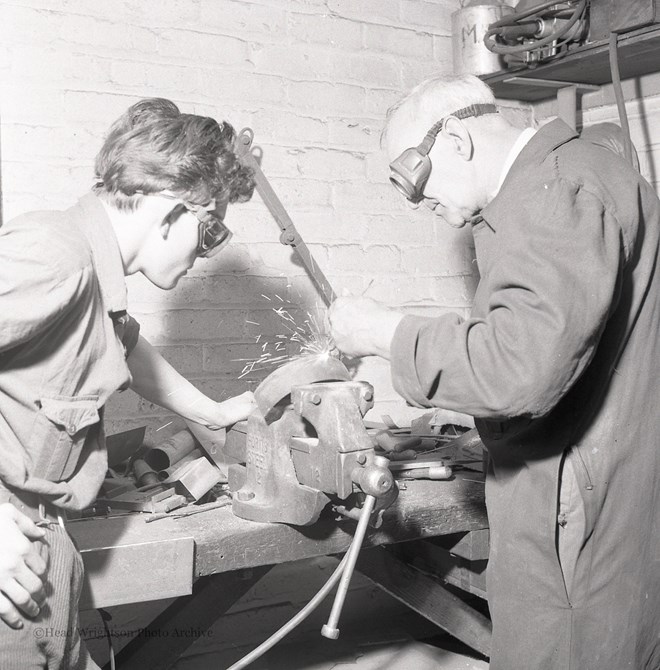 Photographs of apprentices being shown a job