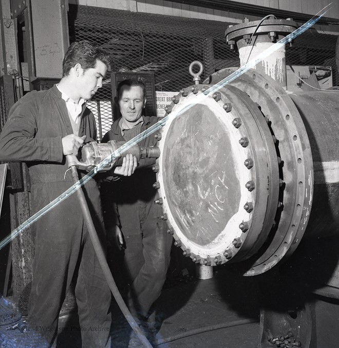 Photographs of apprentices being shown a job