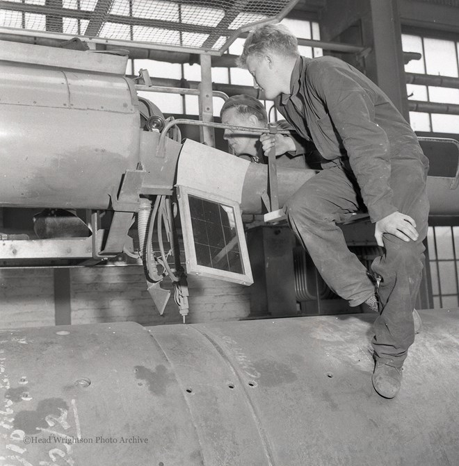 Photographs of apprentices being shown a job