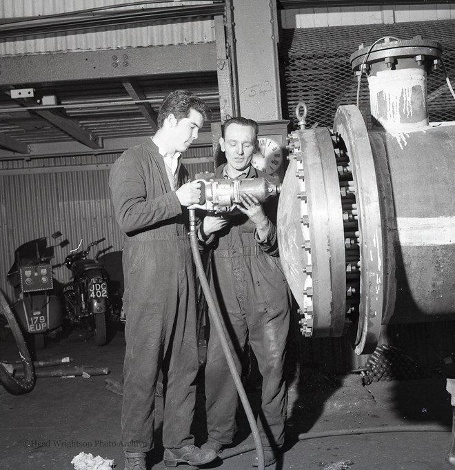 Photographs of apprentices being shown a job