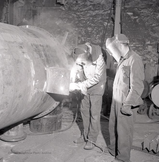 Photographs of apprentices being shown a job