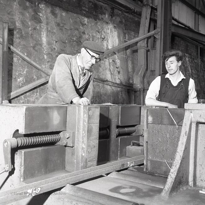 Photographs of apprentices being shown a job