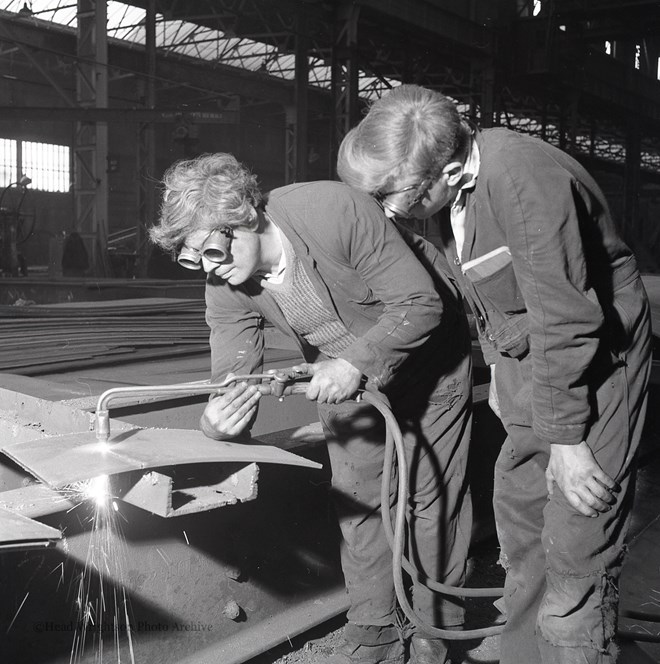 Photographs of apprentices being shown a job