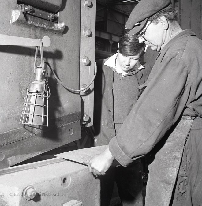 Photographs of apprentices being shown a job