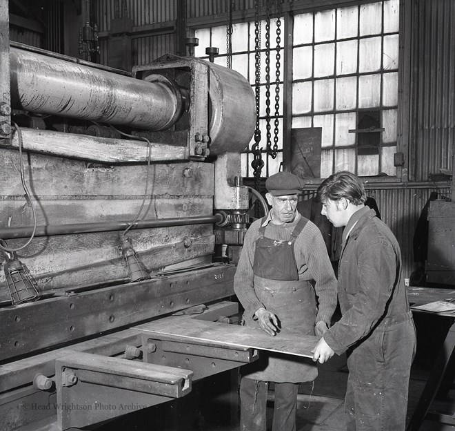 Photographs of apprentices being shown a job