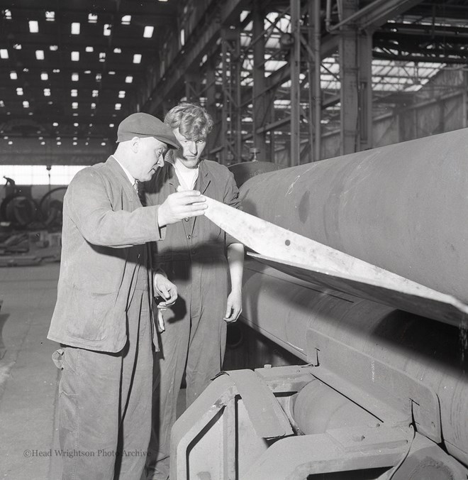 Photographs of apprentices being shown a job