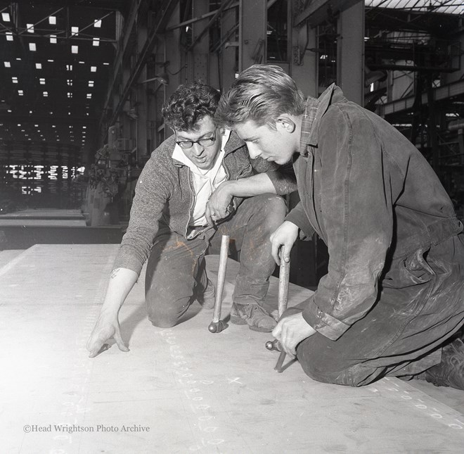 Photographs of apprentices being shown a job