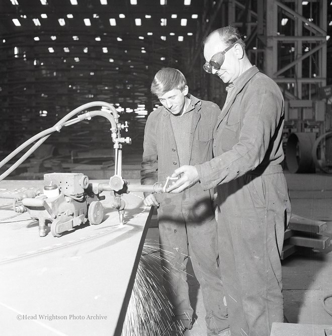 Photographs of apprentices being shown a job