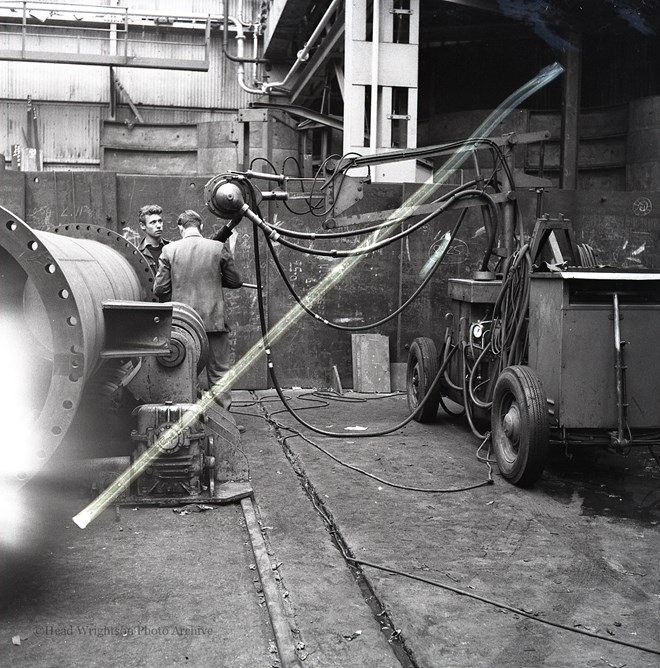 Photographs of apprentices being shown a job