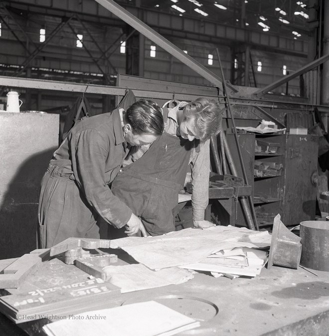 Photographs of apprentices being shown a job