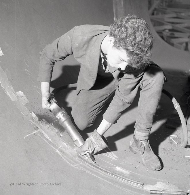 Photographs of apprentices being shown a job