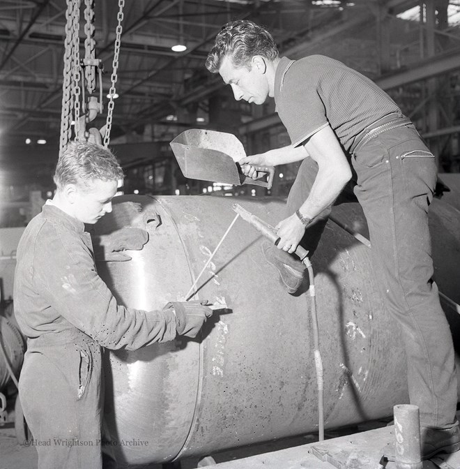 Photographs of apprentices being shown a job