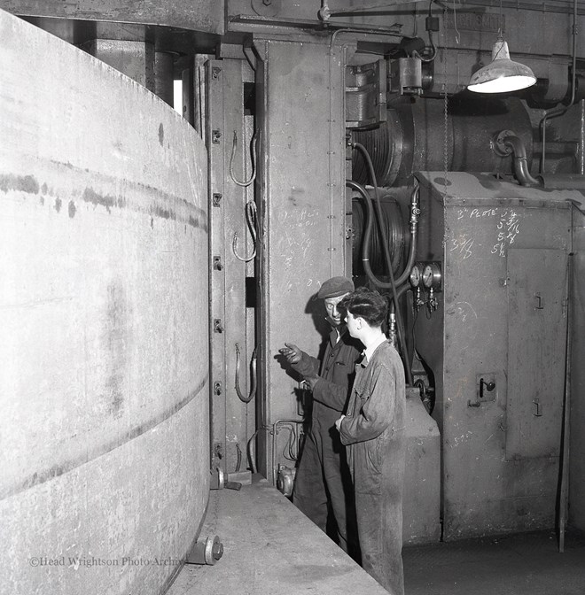 Photographs of apprentices being shown a job