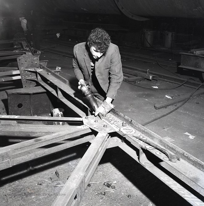 Photographs of apprentices being shown a job