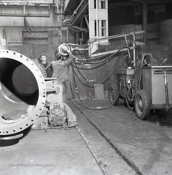 Photographs of apprentices being shown a job