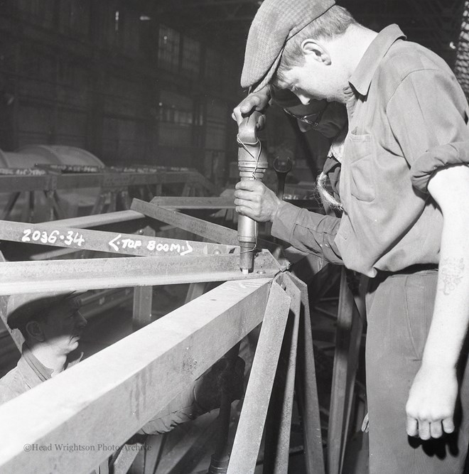 Photographs of apprentices being shown a job