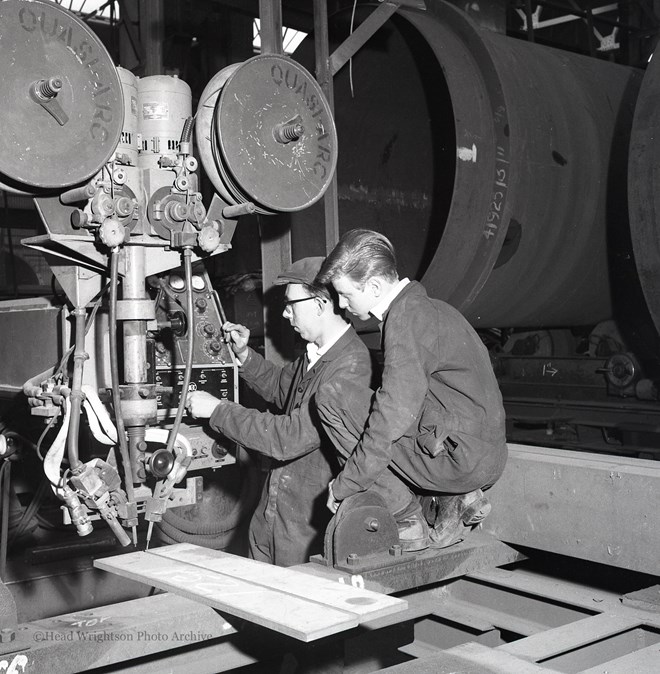 Photographs of apprentices being shown a job