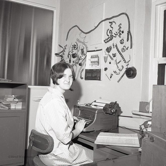 Secretary With Metal Turnings At Machine Co.