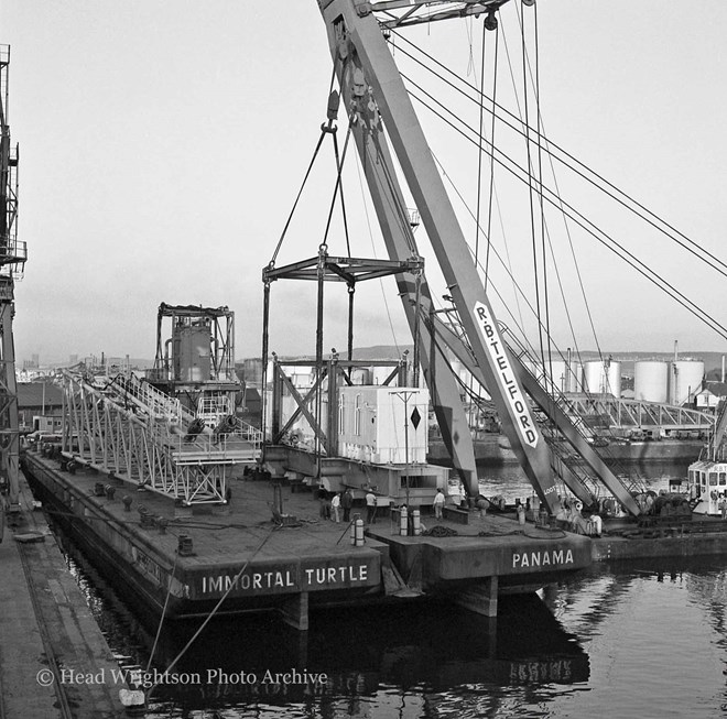 Floating crane loading equipment onto barge, Middlesbrough Docks