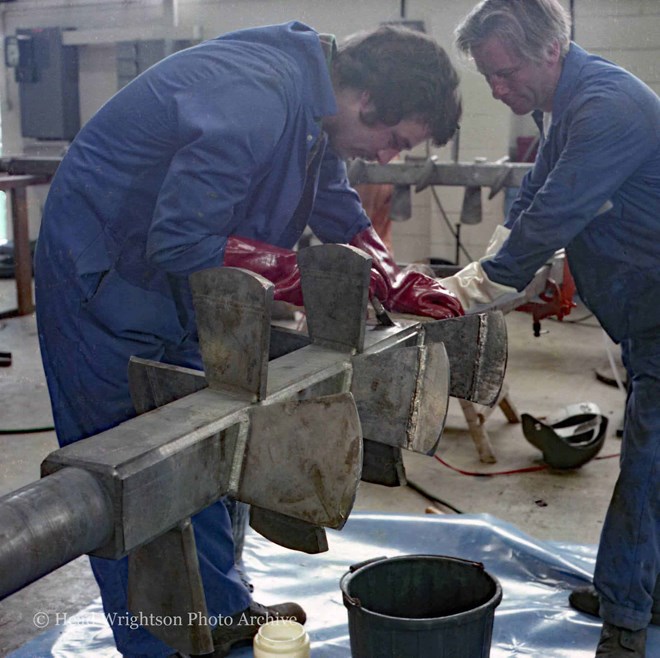 Various men completing finished products around the factory