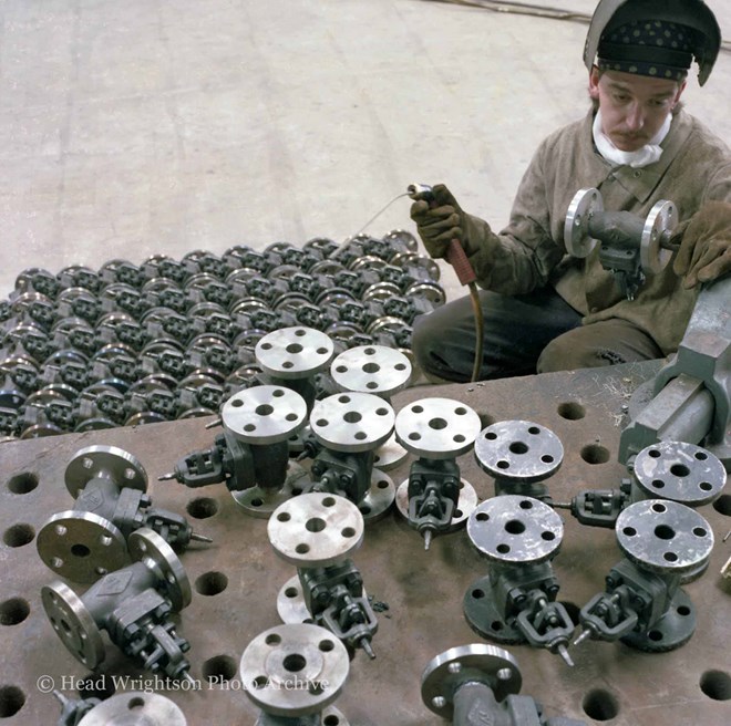 Various men completing finished products around the factory
