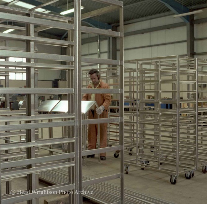 Various men completing finished products around the factory