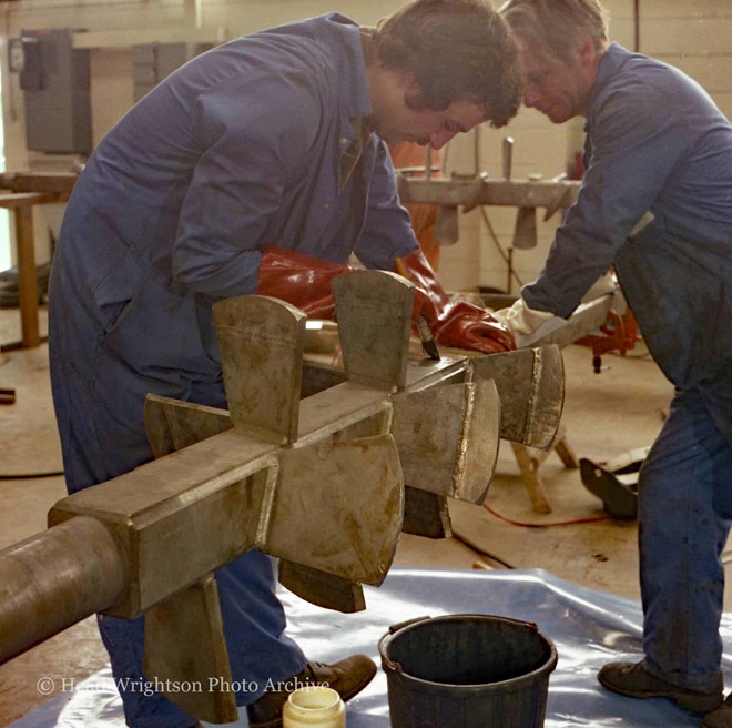 Various men completing finished products around the factory