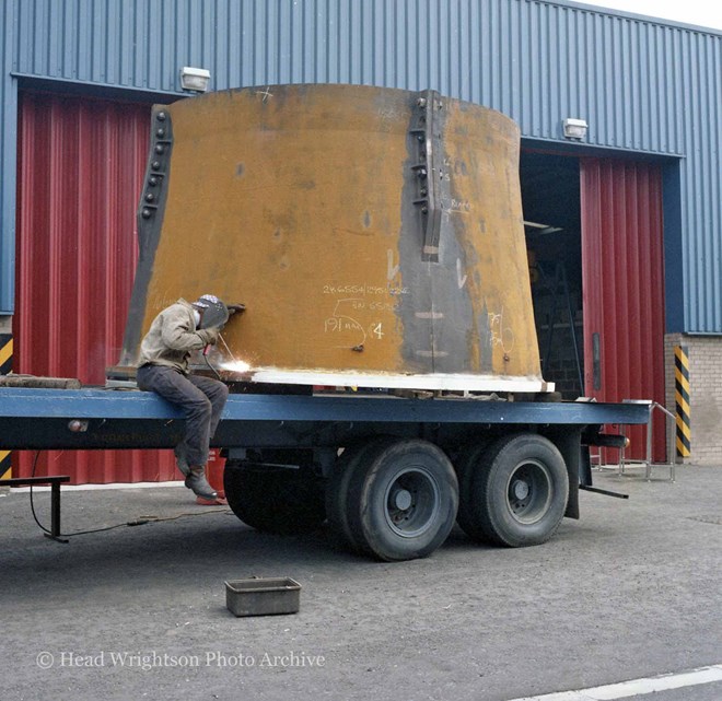 Various men completing finished products around the factory