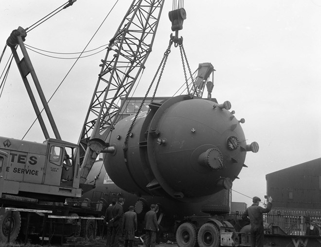 lifting orange vessels onto wagons