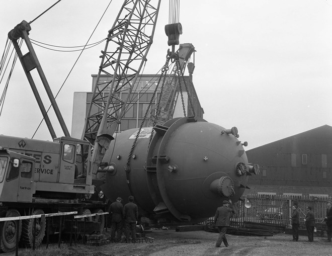 lifting orange vessels onto wagons