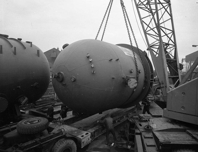 lifting orange vessels onto wagons