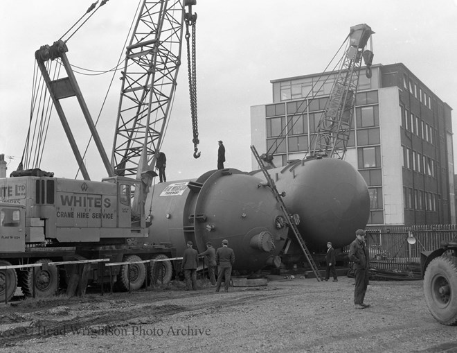 lifting orange vessels onto wagons