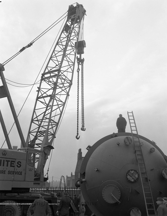 lifting orange vessels onto wagons