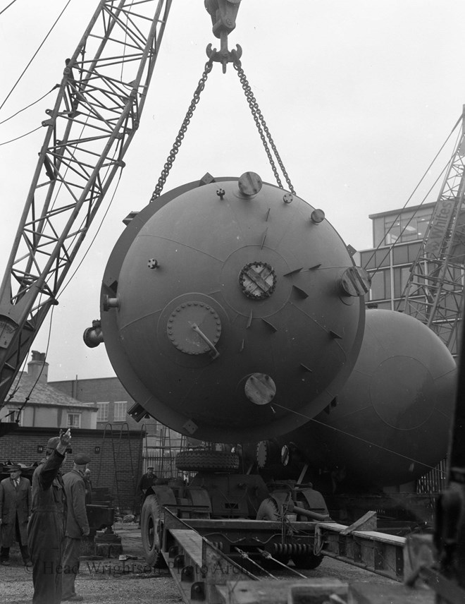 lifting orange vessels onto wagons