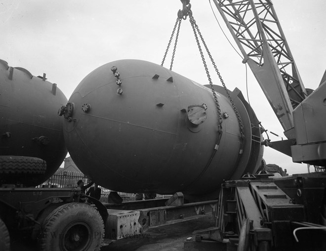 lifting orange vessels onto wagons