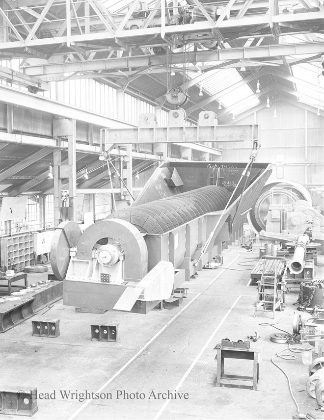 A lifting beam is being used by an overhead crane to lift a classifier in a Stockton forge fitting shop.