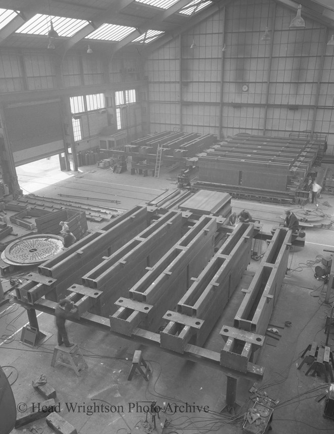 Various stages of manufacture of aluminium smelter pots from crane tracks